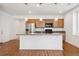 Modern kitchen featuring stainless steel appliances and a large island at 9674 Truckee St, Commerce City, CO 80022