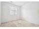 Spacious bedroom with neutral carpeting and a window at 9674 Truckee St, Commerce City, CO 80022