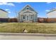 Charming craftsman style home with a well-manicured lawn at 2963 Rose Hill St, Strasburg, CO 80136