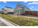 Craftsman style home with a green exterior and yard at 2963 Rose Hill St, Strasburg, CO 80136