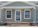 Inviting front porch with a classic front door at 2963 Rose Hill St, Strasburg, CO 80136