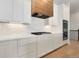 Kitchen with white cabinets, wood range hood, and stainless steel appliances at 23835 E River Front Dr, Aurora, CO 80019