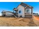 Two-story house with gray and white siding, deck, and stairs leading to backyard at 23835 E River Front Dr, Aurora, CO 80019