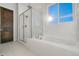 Bathroom with walk-in shower, soaking tub, and window at 23835 E River Front Dr, Aurora, CO 80019
