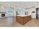 Open kitchen with island, white cabinets, stainless steel appliances, and hardwood floors at 23835 E River Front Dr, Aurora, CO 80019