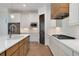 Kitchen with white cabinets, wood island, and stainless steel appliances at 23835 E River Front Dr, Aurora, CO 80019