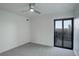 Bedroom with gray carpet, white brick wall, and balcony access at 460 S Marion Pkwy # 706, Denver, CO 80209