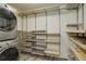 Laundry room with washer, dryer, and ample shelving at 460 S Marion Pkwy # 706, Denver, CO 80209