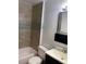 Bathroom with tub, toilet, and dark vanity at 677 Vrain St # 3, Denver, CO 80204