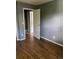 Simple bedroom with wood-look floors and gray walls at 677 Vrain St # 3, Denver, CO 80204