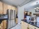 Stainless steel refrigerator in a kitchen with light wood cabinets at 6220 Salvia St, Arvada, CO 80403