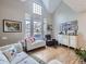 Bright living room with hardwood floors, large windows, and comfortable seating at 6220 Salvia St, Arvada, CO 80403