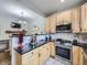 Open concept kitchen with breakfast bar and stainless steel appliances at 6220 Salvia St, Arvada, CO 80403