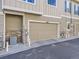 Attached garage with tan door and stone accents at 6220 Salvia St, Arvada, CO 80403