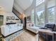 Open living room with hardwood floors, large windows, and access to deck at 6220 Salvia St, Arvada, CO 80403