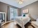Bright bedroom with a white metal bed frame and wood floors at 6220 Salvia St, Arvada, CO 80403