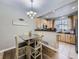 Kitchen with light wood cabinets, breakfast bar, and dining area at 6220 Salvia St, Arvada, CO 80403