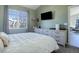 Bedroom with a queen bed, dresser, and TV, offering comfort and entertainment at 4079 S Crystal Cir # 201, Aurora, CO 80014