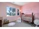 Bedroom with crib, changing table, and playful decor at 4079 S Crystal Cir # 201, Aurora, CO 80014