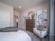 Cozy bedroom with a comfortable bed, dresser, and armchair at 5186 N Quemoy Ct, Aurora, CO 80019