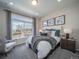 Bedroom with plush carpeting, large window, and stylish furnishings at 5186 N Quemoy Ct, Aurora, CO 80019