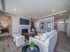 Bright living room with a white sofa, fireplace, and access to the entryway and main bedroom at 5186 N Quemoy Ct, Aurora, CO 80019