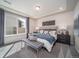 Bright and airy Primary bedroom with large windows, a king-size bed, and a cozy sitting area at 5186 N Quemoy Ct, Aurora, CO 80019