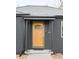 Contemporary wood front door with glass panel and black frame at 1698 S Garfield St, Denver, CO 80210