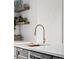 Modern kitchen detail showing a gold faucet and white countertop at 1698 S Garfield St, Denver, CO 80210