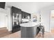 Modern kitchen with white countertops, dark cabinetry, and a center island at 1698 S Garfield St, Denver, CO 80210