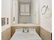 Small bathroom with single sink vanity, mirror and neutral tile at 10438 Holland Pl, Broomfield, CO 80021