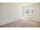 Bright bedroom with carpeted floors and large window at 6153 N Ceylon St # 205, Denver, CO 80249