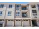 Modern building exterior with attached garages at 6153 N Ceylon St # 205, Denver, CO 80249