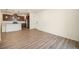 Open living room and kitchen area with laminate floors at 6153 N Ceylon St # 205, Denver, CO 80249