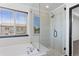 Spa-like bathroom featuring a walk-in shower and a separate bathtub at 11735 Helena St, Commerce City, CO 80022