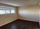 Finished basement room with dark hardwood floors and a window at 137 S Bedford Ave, Castle Rock, CO 80104