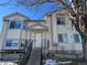 Two-story house with light-beige siding, gray trim, and a staircase leading to the entrance at 137 S Bedford Ave, Castle Rock, CO 80104