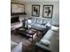 Living room featuring light gray sofas and a fireplace at 2262 Ammons St, Lakewood, CO 80214