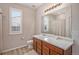 Clean bathroom with wood cabinets and a large mirror at 41 S Jackson Gap Way, Aurora, CO 80018