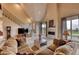 Spacious living room with fireplace, large windows, and access to a deck at 5236 Bear Mountain Dr, Evergreen, CO 80439