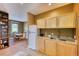 Small kitchenette with white refrigerator, wood cabinets, and granite countertop at 5236 Bear Mountain Dr, Evergreen, CO 80439