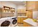 Laundry room with washer, dryer, cabinets and sink at 5236 Bear Mountain Dr, Evergreen, CO 80439