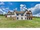 House exterior showcasing two-story home with large deck and attached garage at 5236 Bear Mountain Dr, Evergreen, CO 80439