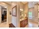 Elegant bathroom with a large vanity, soaking tub, and walk-in closet at 5236 Bear Mountain Dr, Evergreen, CO 80439