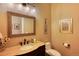 Powder room with vanity, toilet and decorative artwork at 5236 Bear Mountain Dr, Evergreen, CO 80439