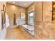 Relaxing bathroom featuring a large soaking tub and a view at 5236 Bear Mountain Dr, Evergreen, CO 80439