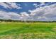 Large lot with lush green grass, trees and a small pond at 5236 Bear Mountain Dr, Evergreen, CO 80439