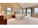 Large main bedroom with high ceilings, access to a deck, and lots of natural light at 5236 Bear Mountain Dr, Evergreen, CO 80439