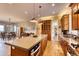 Open concept kitchen with island seating and views into the dining and living areas at 5236 Bear Mountain Dr, Evergreen, CO 80439