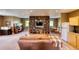 Finished basement with living area, bookcase and wet bar at 5236 Bear Mountain Dr, Evergreen, CO 80439